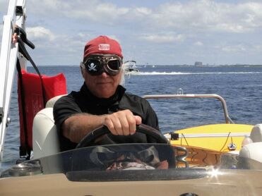 Captain driving a pontoon boat